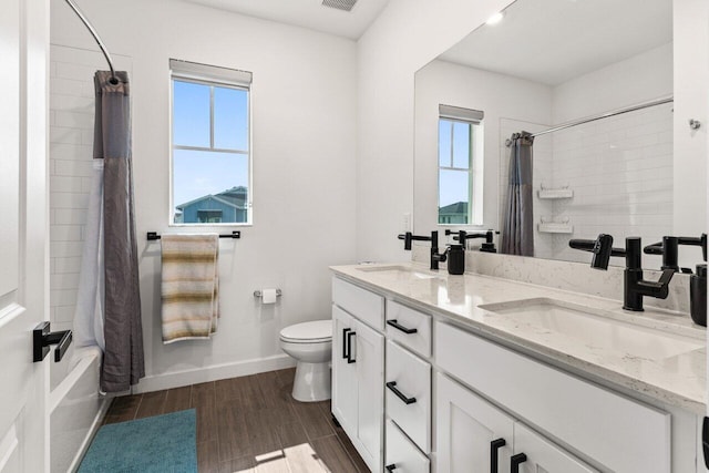 full bathroom with vanity, shower / bathtub combination with curtain, and toilet