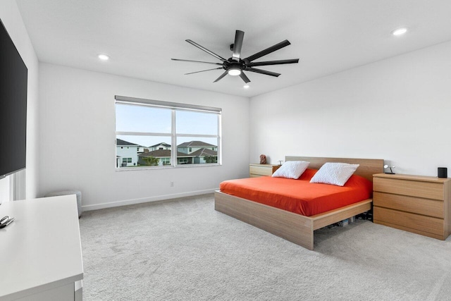 bedroom featuring light carpet and ceiling fan