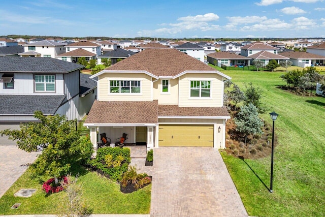 view of front of house with a garage and a front yard