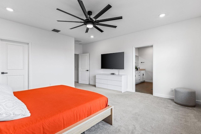 bedroom featuring ceiling fan, ensuite bath, and carpet