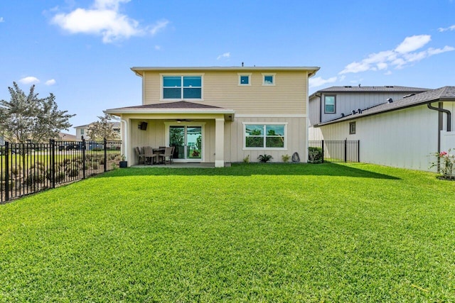 back of property with ceiling fan, a patio, and a lawn