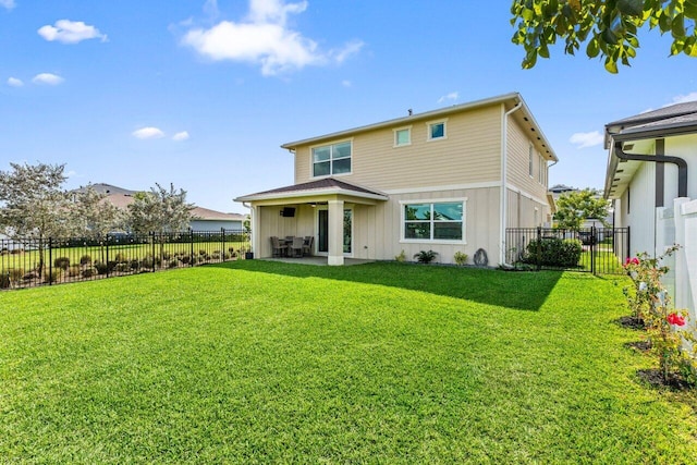 rear view of property featuring a yard and a patio