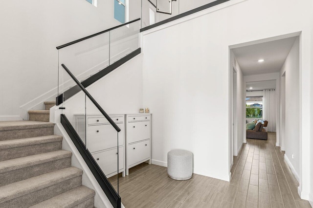 stairs with hardwood / wood-style floors