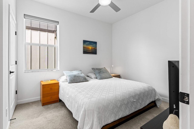 bedroom with light colored carpet and ceiling fan