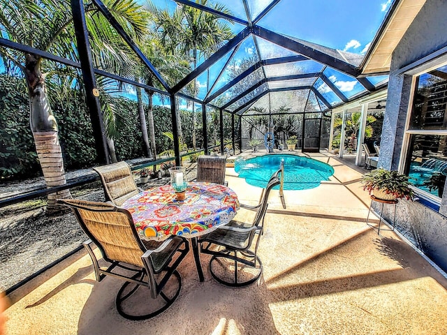 view of swimming pool with glass enclosure and a patio area