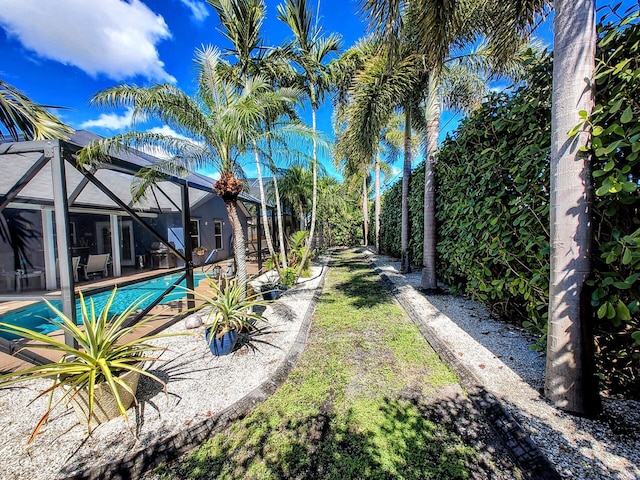 view of yard featuring glass enclosure