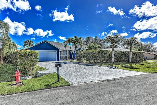 view of front of home with a front lawn and a garage