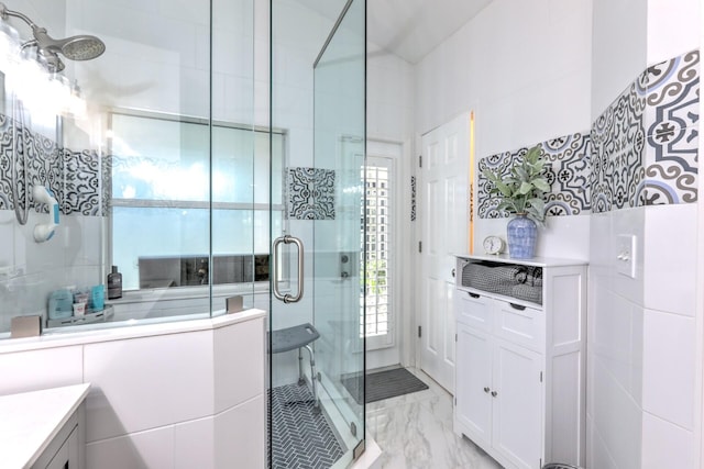 bathroom featuring tile walls, vanity, and walk in shower