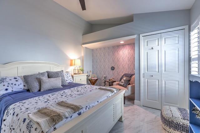 bedroom featuring a closet, lofted ceiling, and ceiling fan