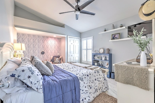 bedroom featuring ceiling fan, a closet, and lofted ceiling