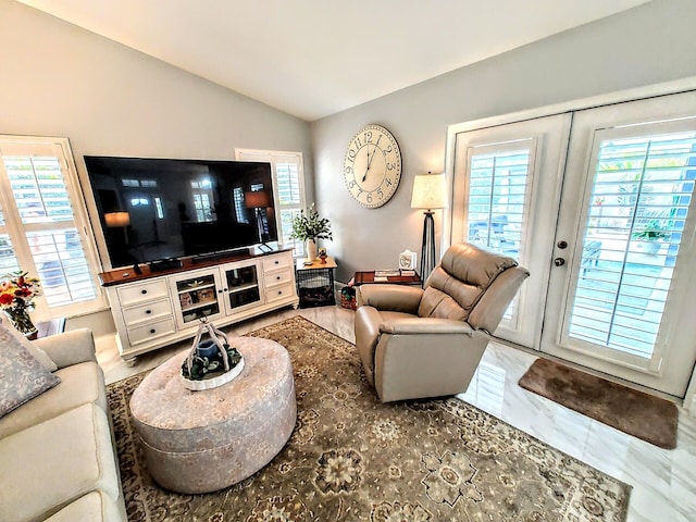 living room featuring french doors, vaulted ceiling, and a wealth of natural light