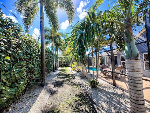 view of yard with a patio and a lanai