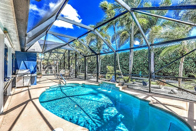 view of swimming pool featuring glass enclosure, a patio area, and pool water feature