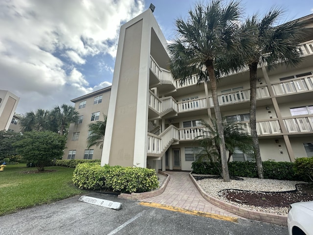 view of property featuring uncovered parking