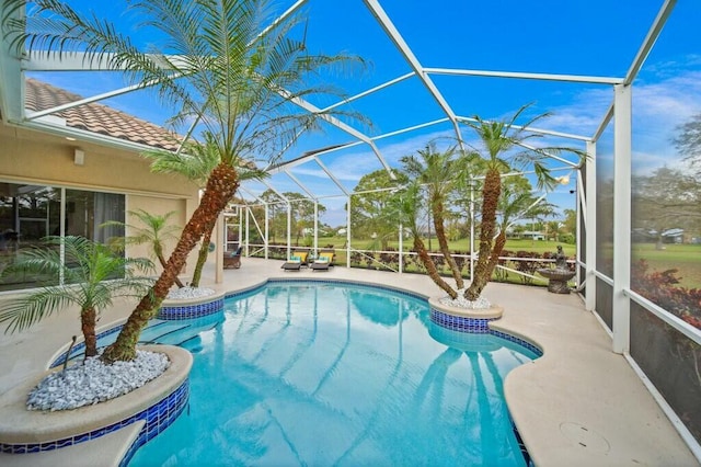 pool with glass enclosure and a patio