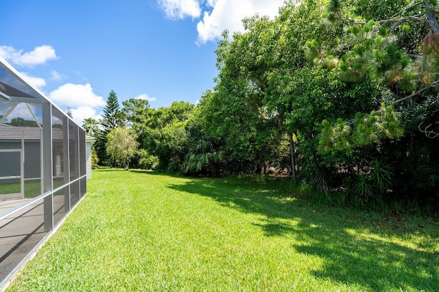 view of yard featuring a lanai