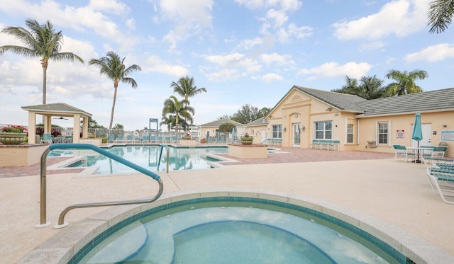 community pool with a gazebo, a patio, and a community hot tub