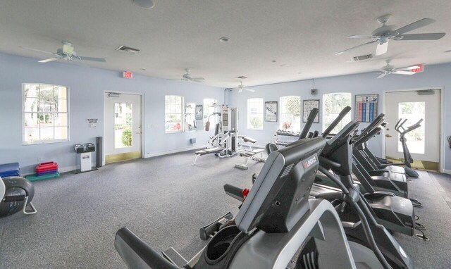 exercise room with baseboards and visible vents