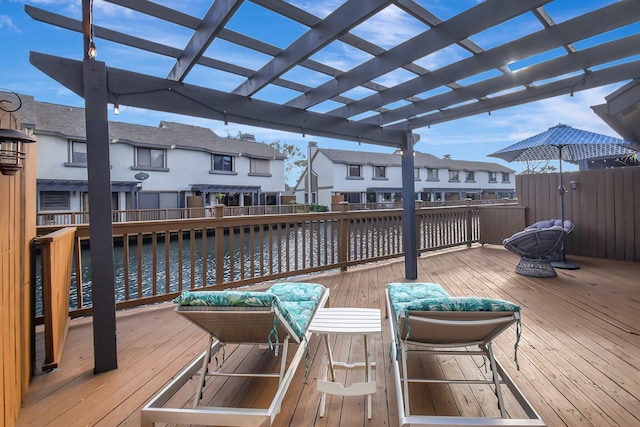 deck featuring a residential view, a water view, and a pergola