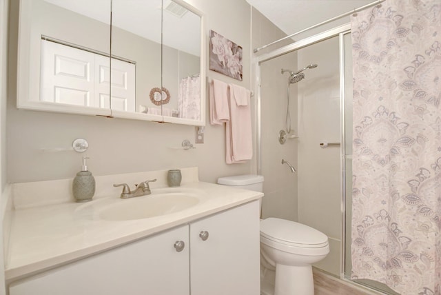 full bath featuring curtained shower, vanity, and toilet