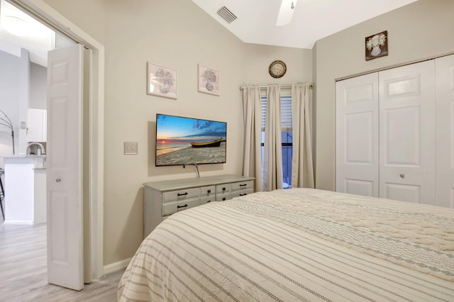 bedroom featuring a closet, visible vents, ceiling fan, light wood-type flooring, and baseboards