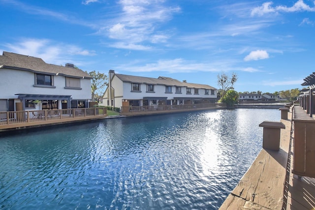 exterior space featuring a residential view, a water view, a swimming pool, and a pergola