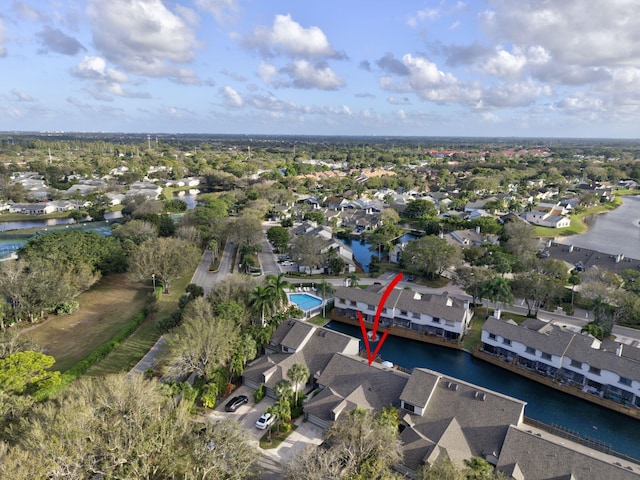 drone / aerial view with a water view and a residential view