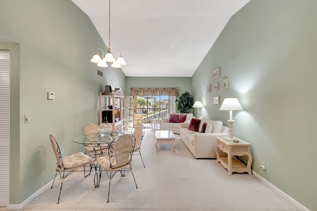 carpeted dining area with a chandelier, high vaulted ceiling, and baseboards