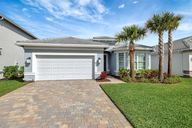 view of front of property with a front yard, decorative driveway, and stucco siding