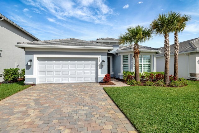 9633 Mosler Trl, Lake Worth, FL 33467 - prairie-style home with decorative driveway, stucco siding, a front yard, and an attached garage
