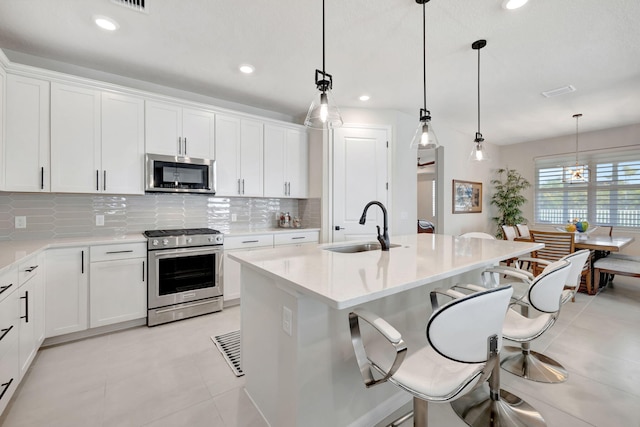 9633 Mosler Trl, Lake Worth, FL 33467 - kitchen with appliances with stainless steel finishes, backsplash, light countertops, white cabinets, and recessed lighting