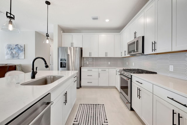 9633 Mosler Trl, Lake Worth, FL 33467 - kitchen with stainless steel appliances, light countertops, tasteful backsplash, white cabinetry, and recessed lighting