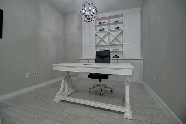 office featuring wood tiled floor, baseboards, and a notable chandelier