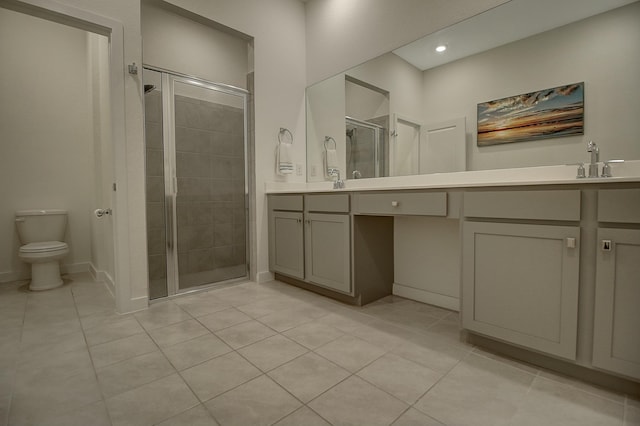 full bath with tile patterned flooring, toilet, vanity, baseboards, and a stall shower