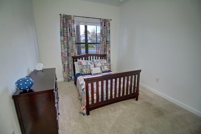 bedroom featuring carpet and baseboards