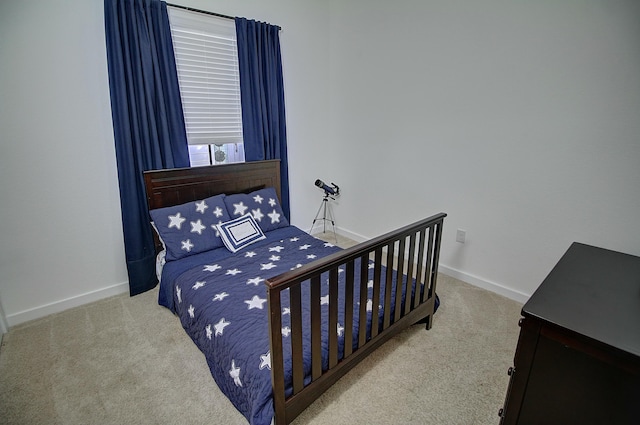 carpeted bedroom featuring baseboards