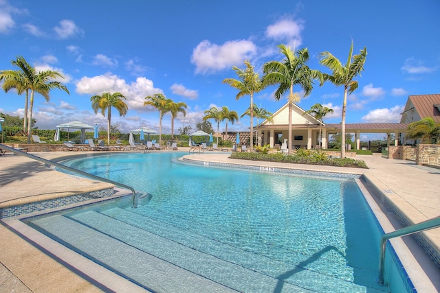 community pool with a gazebo, a pergola, and a patio