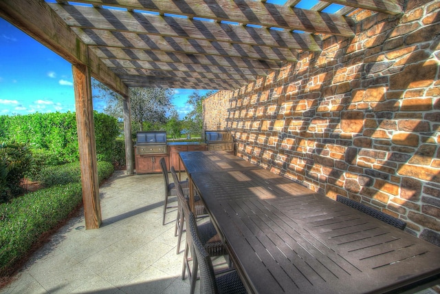 exterior space with an outdoor kitchen and a pergola