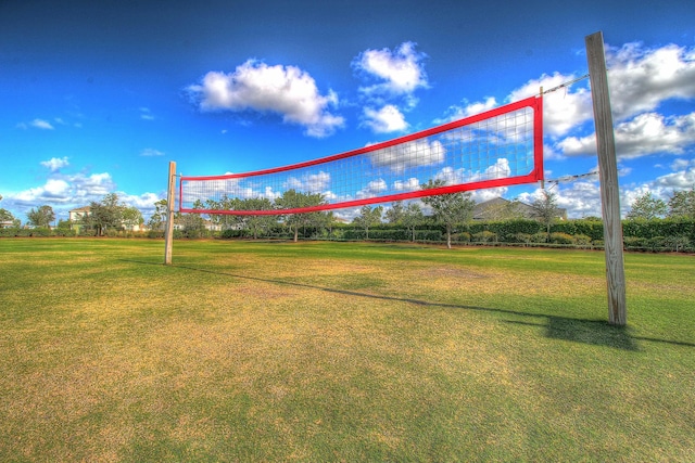 surrounding community featuring a lawn and volleyball court