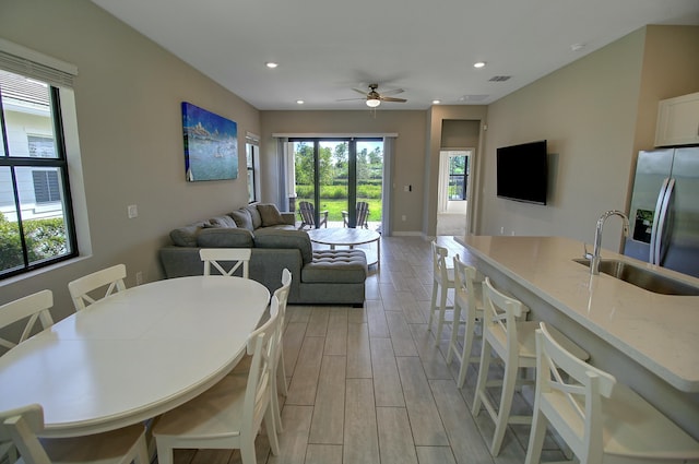 dining area featuring wood finish floors, a healthy amount of sunlight, visible vents, and recessed lighting