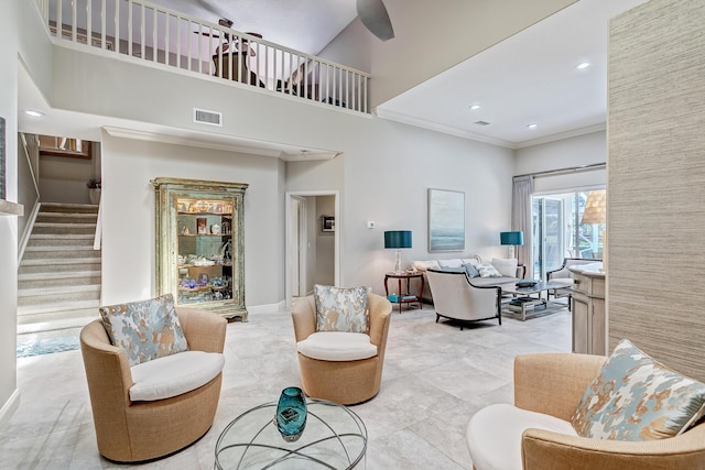 living room with crown molding and a towering ceiling