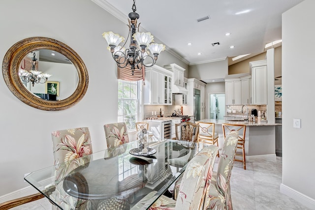 dining area featuring crown molding, sink, wine cooler, and a notable chandelier