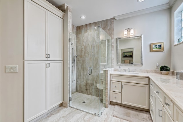 bathroom featuring vanity, crown molding, and a shower with shower door