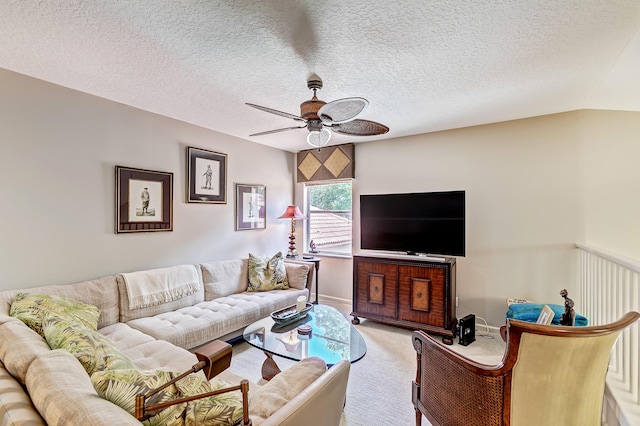 carpeted living room featuring lofted ceiling, a textured ceiling, and ceiling fan