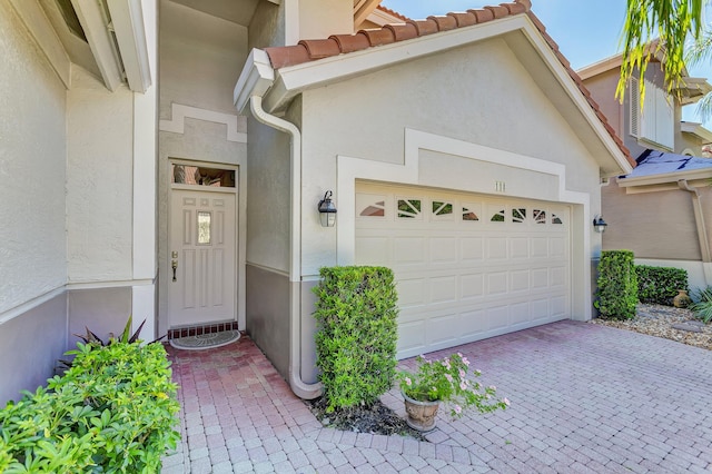 doorway to property featuring a garage