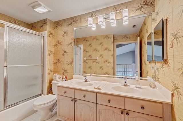 full bathroom featuring vanity, tile patterned flooring, enclosed tub / shower combo, and toilet