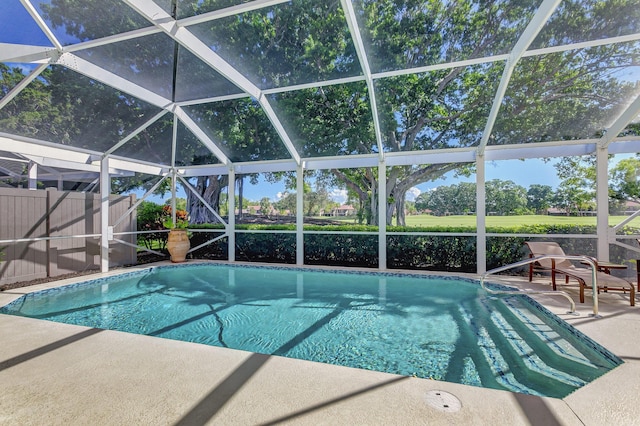 view of pool with a patio and a lanai