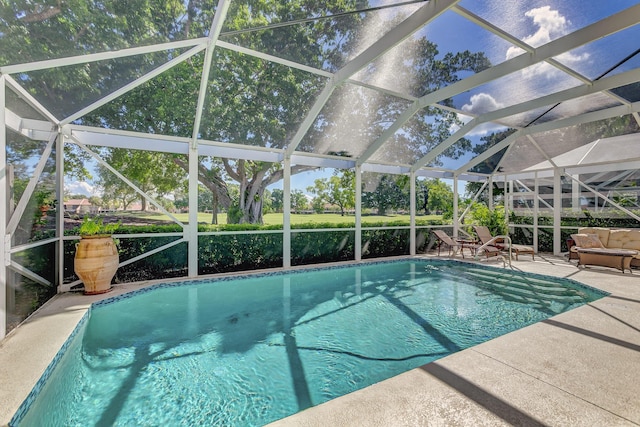 view of pool with a lanai and a patio area