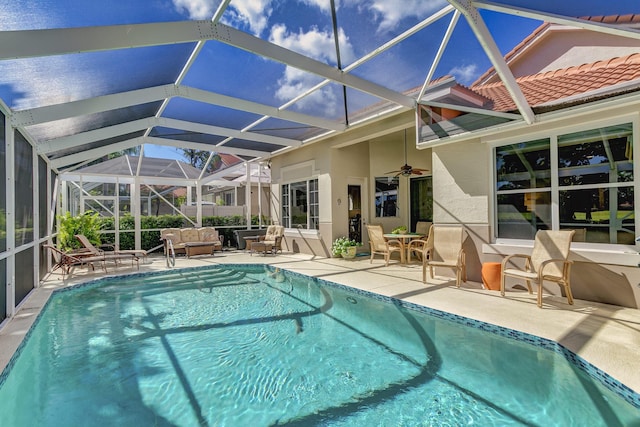 view of pool featuring an outdoor hangout area, a lanai, a patio area, and ceiling fan