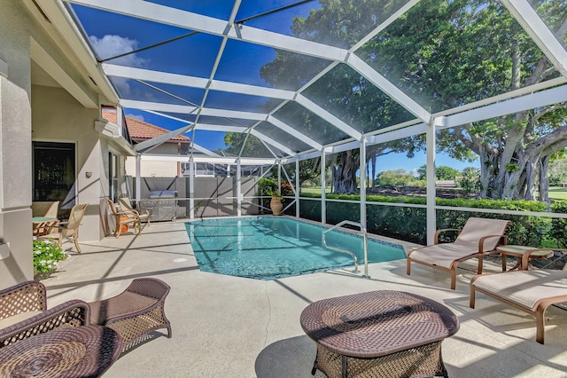 view of swimming pool featuring a lanai and a patio